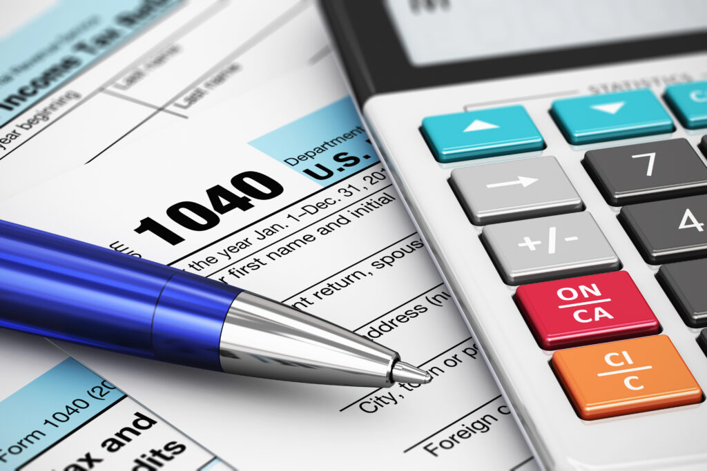 Tax document with calculator and pen