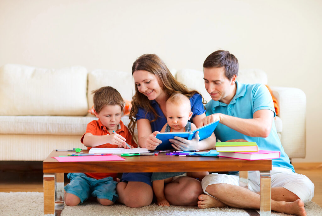 Young family with toddler and baby at home